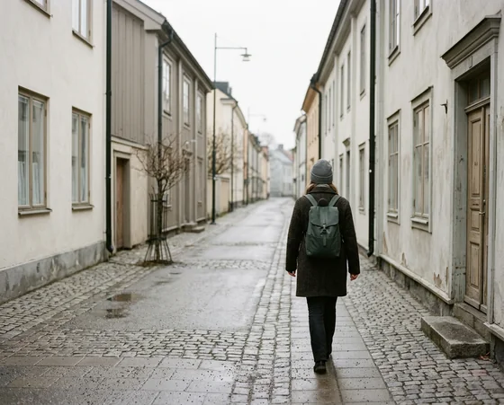 A person walking away down a quiet Nordic street
